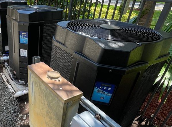 Two Gulfstream pool heat pumps on an equipment pad