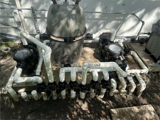 Pool pumps, a filter and new plumbing on a residential equipment pad