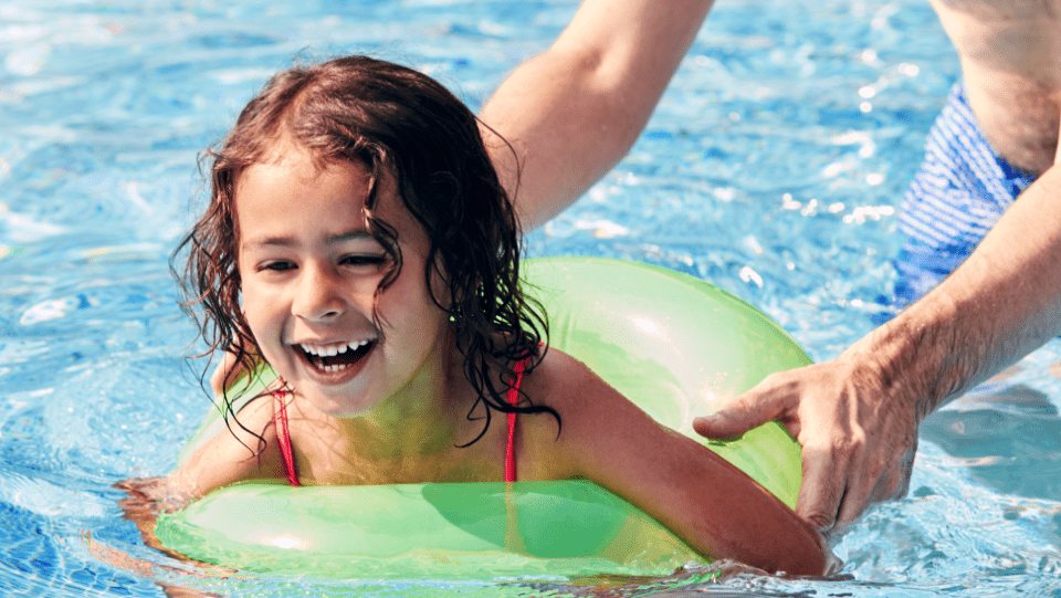 Father teaching his daughter to swim